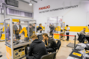room of people looking at FANUC's automation equipment
