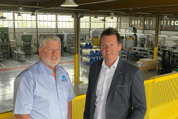 Barry Davidson, left, standing with a colleague inside a modern manufacturing facility.