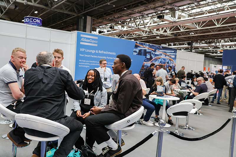Attendees networking in a seated lounge area at The Advanced Materials Show.