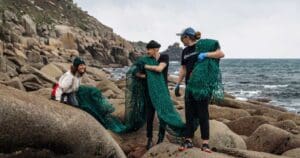 The Waterhaul team on rocks on the coast finding and collection littered fishing lines.