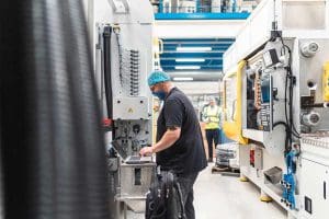 A Bericap worker utilsing the new PAC-E machine.
