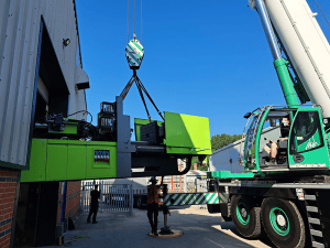 The ENGEL machine being lifted into the factory.